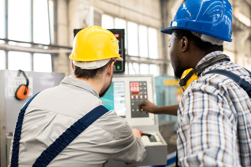 Busy workers discussing program of fully automated factory