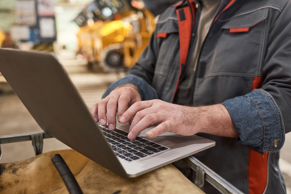 Engineer working on laptop to calculate cycle time