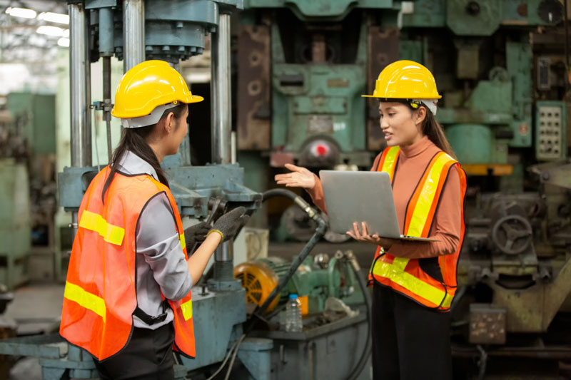 Industrial factory workers discussing green manufacturing