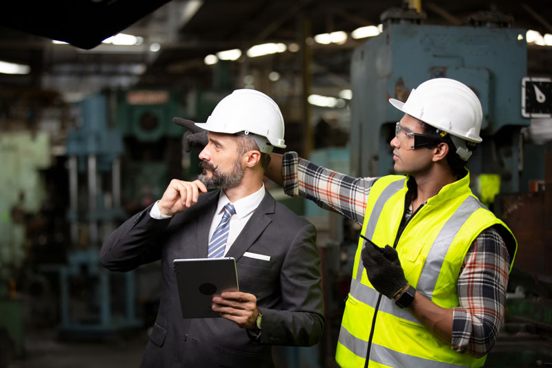 Mean Time Between Failures being examined by two male staff members