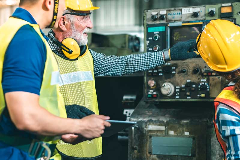 Production counter review by group of factory workers