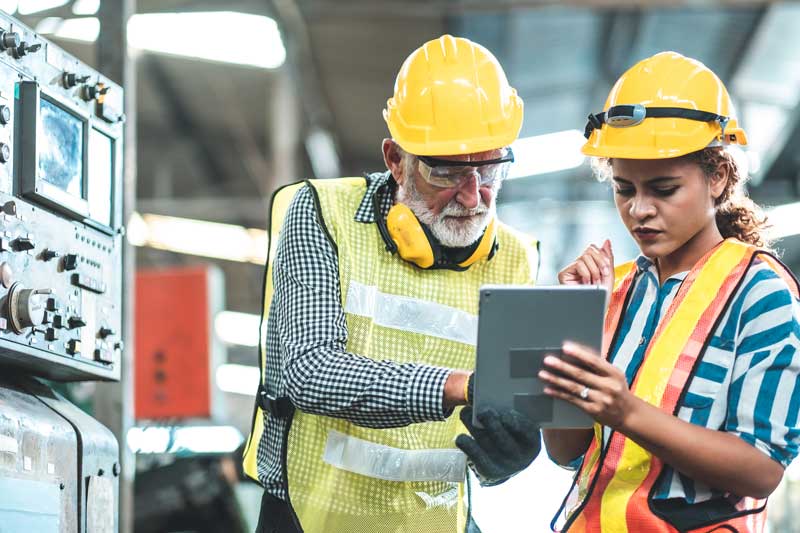 Production counter review by male and female factory workers