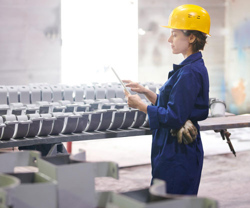 Supervisor at factory reviewing real time production monitoring