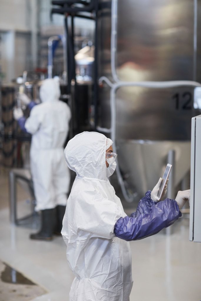 Worker at pharmaceutical factory arranging machine data collection